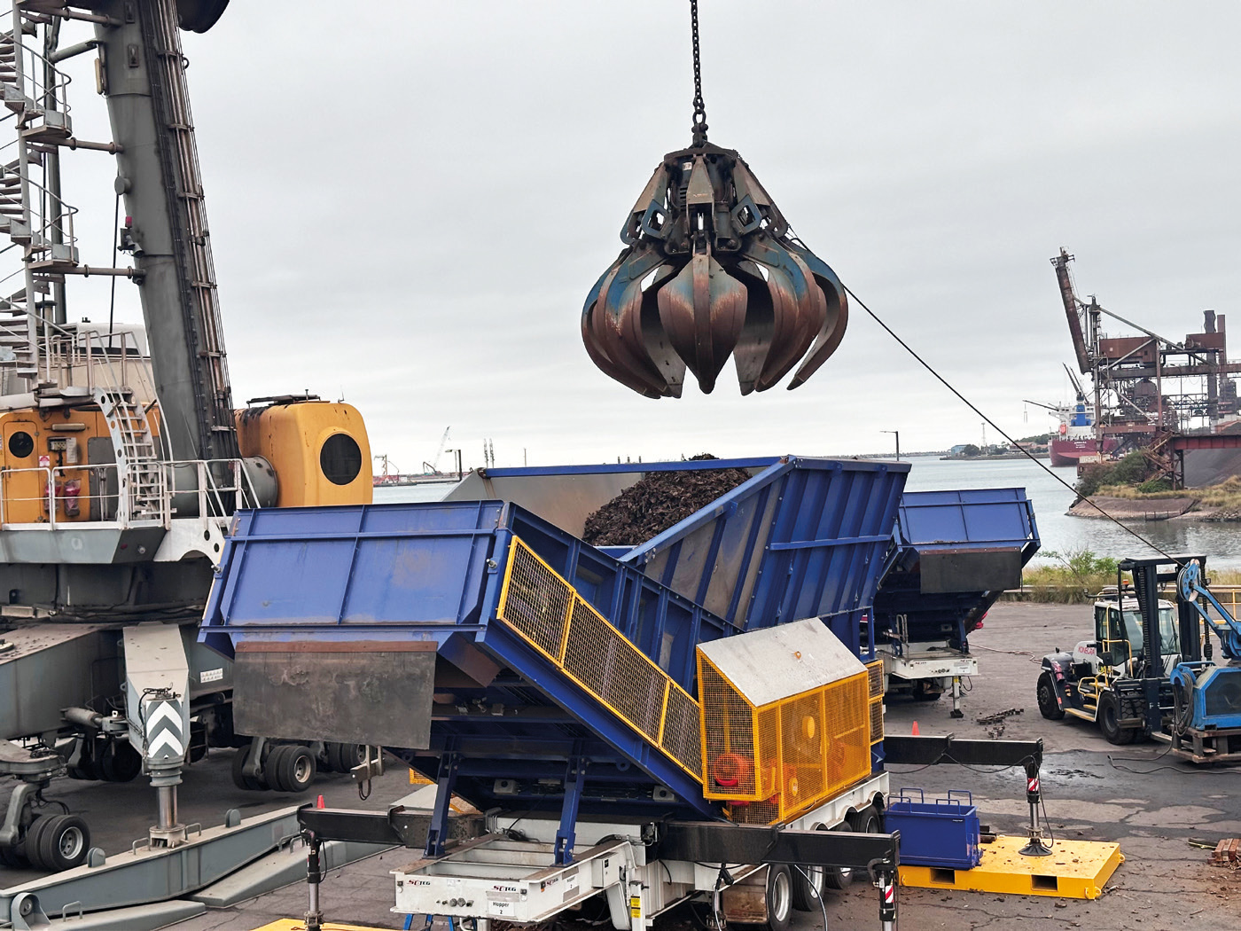 KE-portable-scrap-metal-hopper-port Portable scrap metal hopper working at a port location.